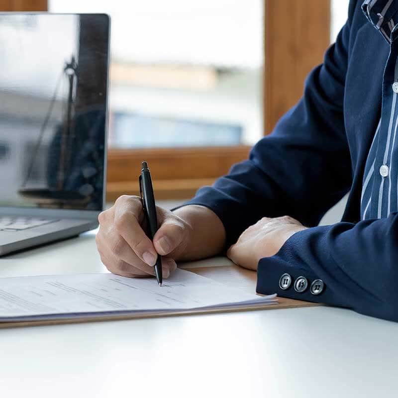 Homem branco preenchendo ficha de licença em um escritório de assessoria Homem branco preenchendo ficha de licença em um escritório de assessoria